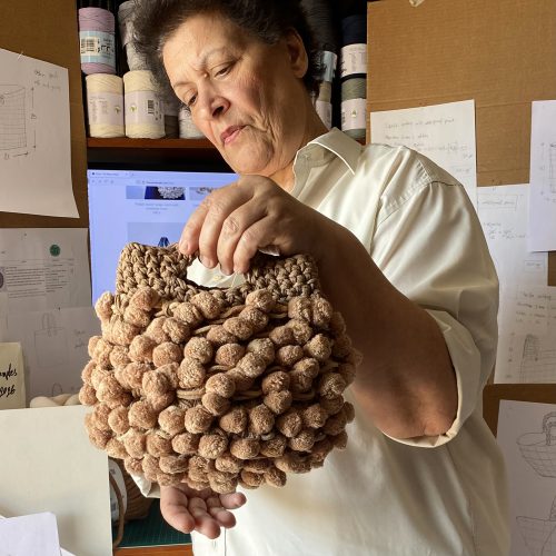 “Nadia pom-pom” crochet handbag sand